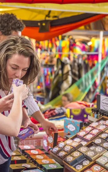 Group of people at Mindil Beach Markets smelling handmade soaps