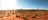 Group of people on quad bikes riding through the desert