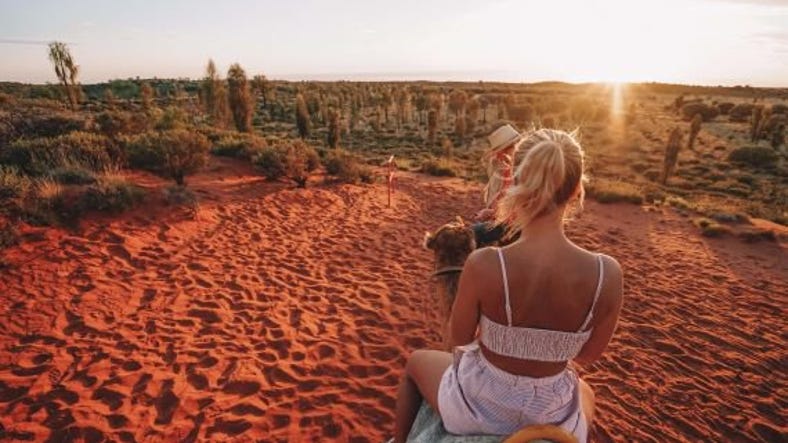 Girl riding camel at sunrise.jpg