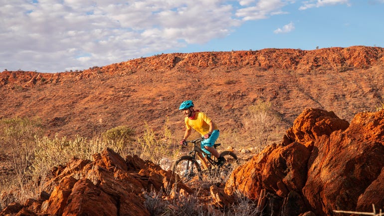 Man-mountain-biking-on Alice-Springs-trail
