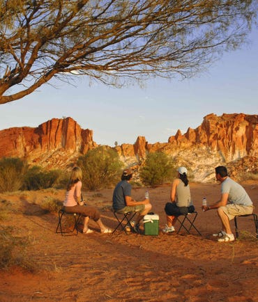 Group of friends sitting together near the Rainbow Valley in Alice Springs