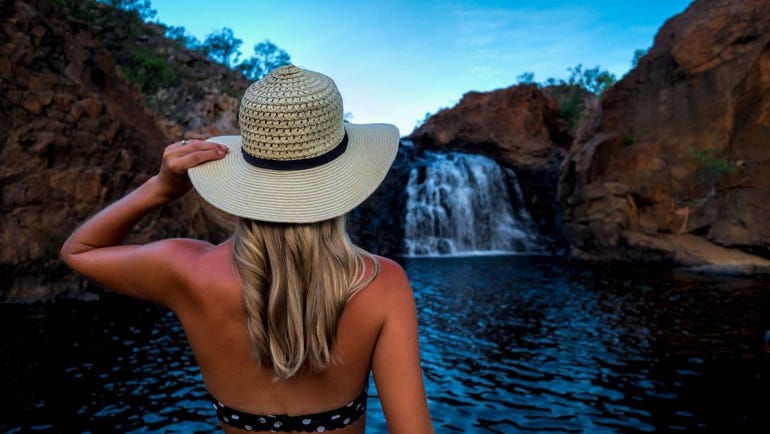 a girl posing in front of edith falls in katherine