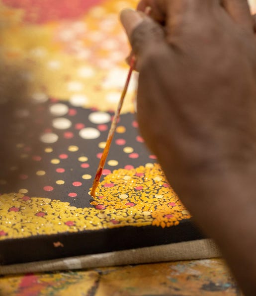 Aboriginal artist painting at Tangentyere Aboriginal Art Centre