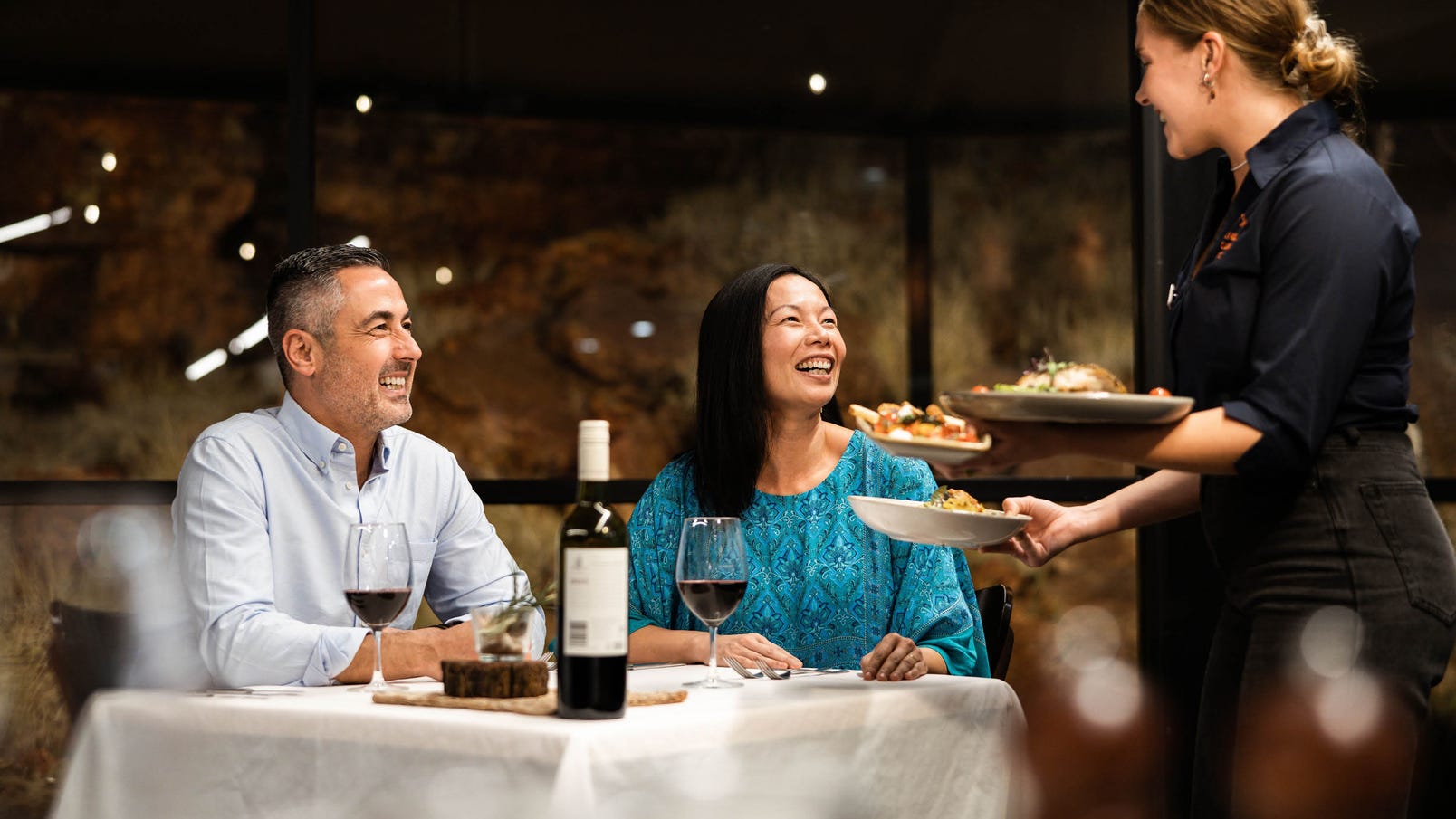 couple being served dinner at carmichaels restaurant in central australia