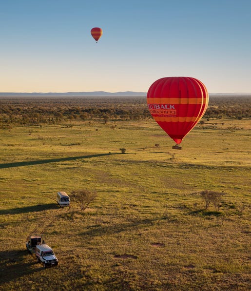 Hot-air-balloon-landing-on green-grass