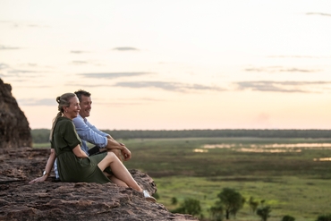 couple looking across the view at Ubirr