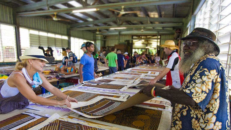 People at an art centre in Tiwi looking at paintings