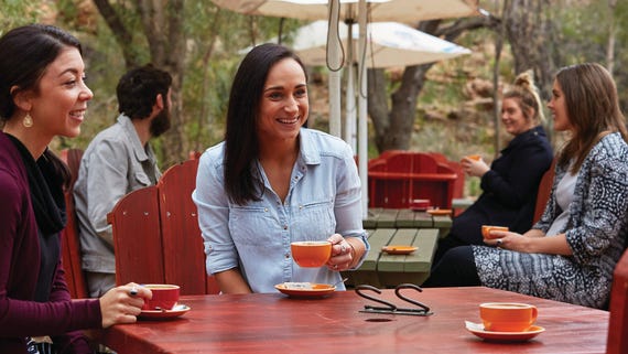 A group of friends drinking coffee at Olive Pink Botanical Gardens in Alice Springs
