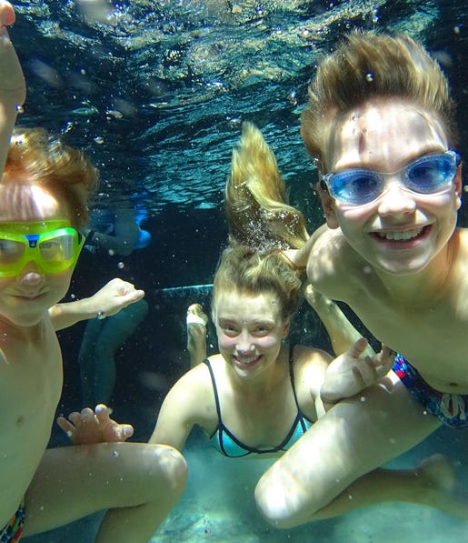 A family swimming in the heated waters at Mataranka
