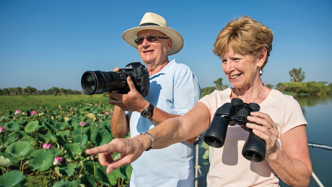 Couple taking photos on a Yellow Water Cruise Kakadu