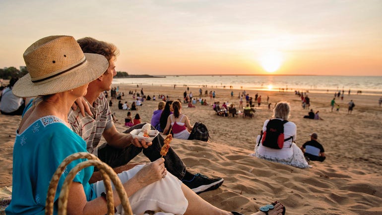 Couple enjoying food while watching the sun set at Mindil Beach Sunset Market