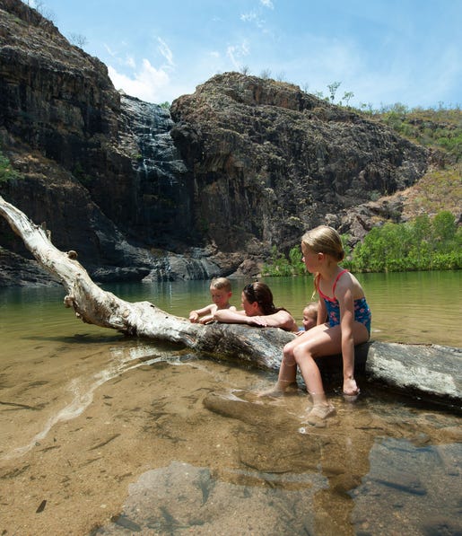 Kids swimming at Gunlom Falls in Kakadu