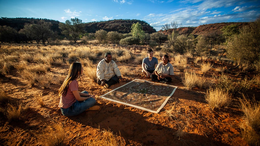 couple sitting in the bush with instructors at the karrke aboriginal cultural experience