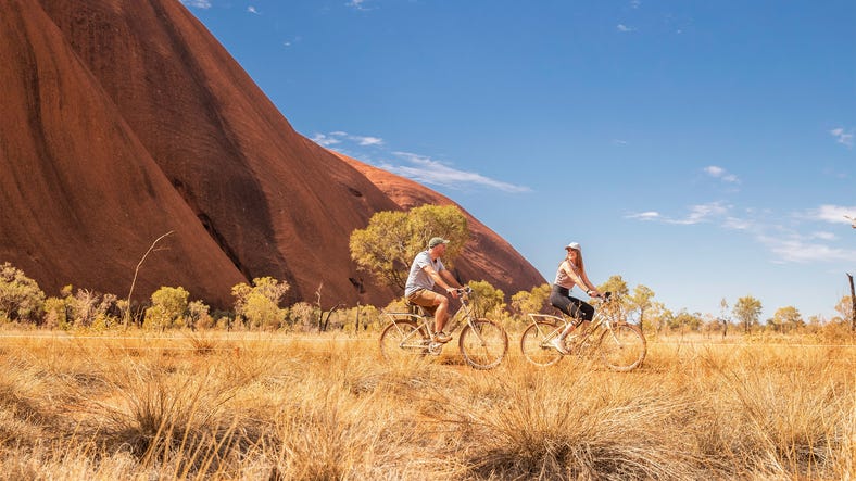 Couple on a bike ride around Uluru