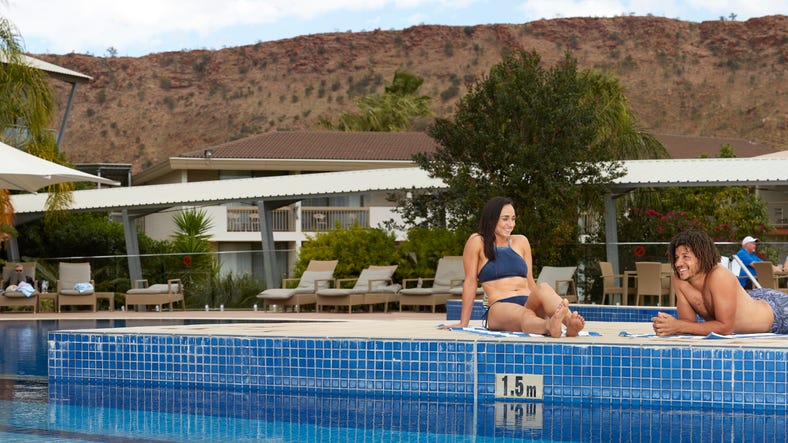 couple at the pool located at crowne plaza lasseters for the bachelor