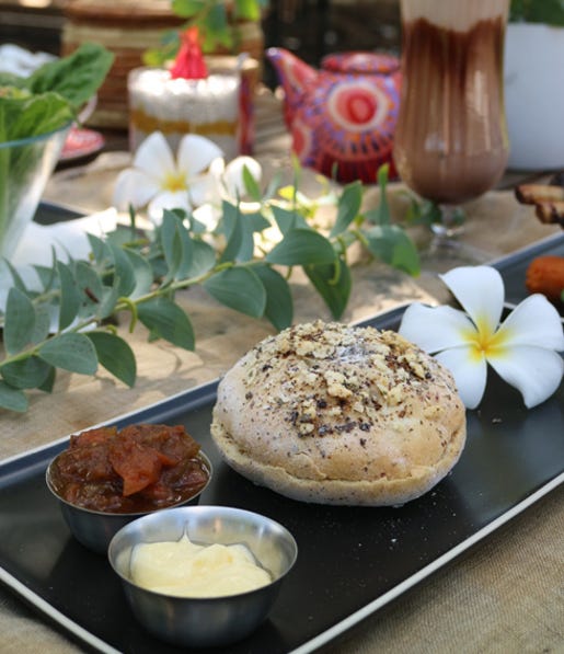 a-damper-loaf-on-a-plate-with-condiments-on-a-table-decorated-with-frang,-d-,cf,-d-,jpg