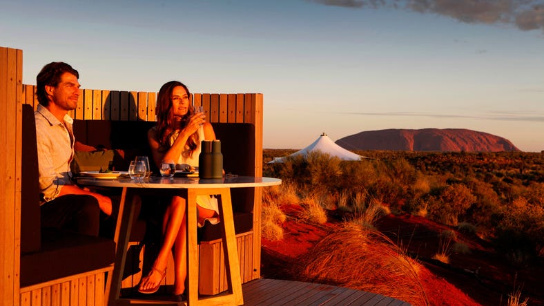 A couple enjoying dinner at sunset near Uluru