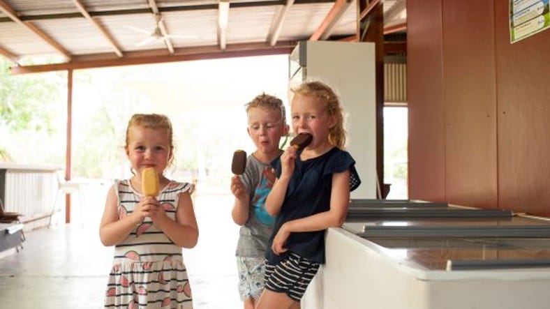 Children eating ice blocks at Crazy Acres Mango Farm