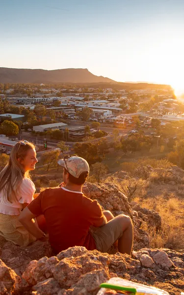 Couple watching the sunsset from Anzac Hill in Alice Springs