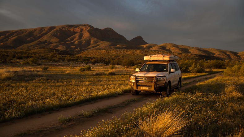 7-A car driving through the West MacDonnell Ranges near Alice Springs