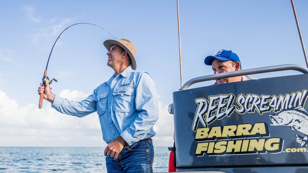 two men fishing for barramundi on a reel screamin tour in darwin harbour
