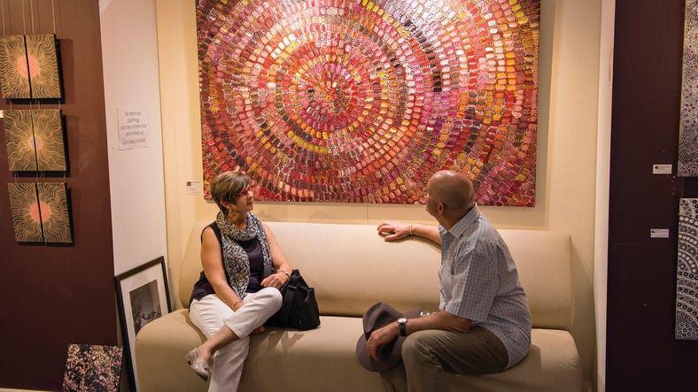 Visitors viewing Aboriginal art in a gallery in Alice Springs