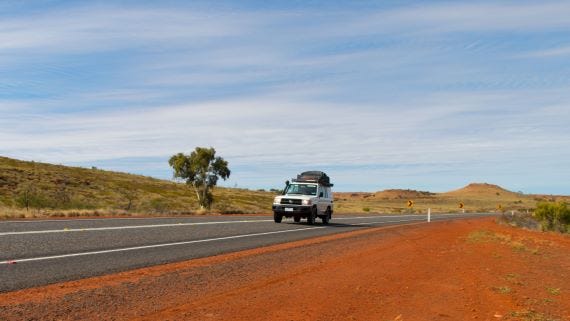 car driving on red centre road.jpg