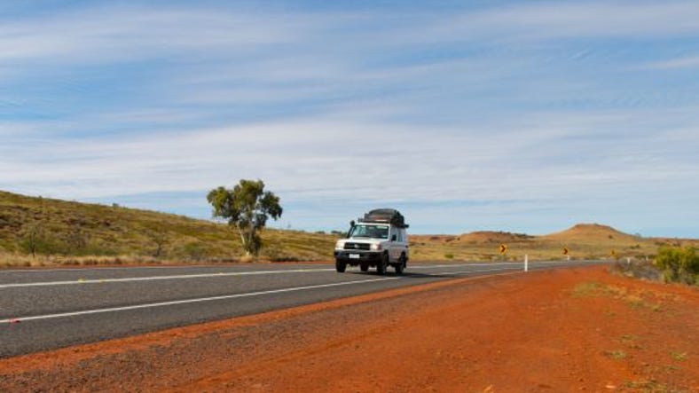 car driving on red centre road.jpg