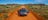 Driving a four wheel drive on a red dirt track near Alice Springs