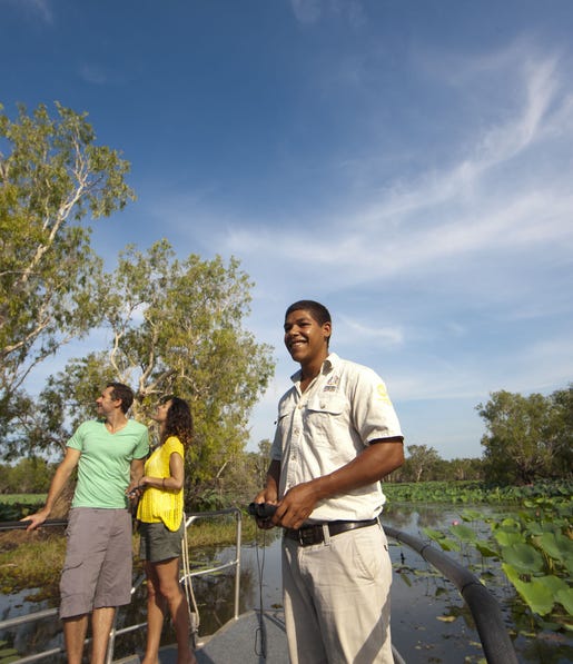 A couple and Aboriginal tour guide on a cruise at Yellow Water