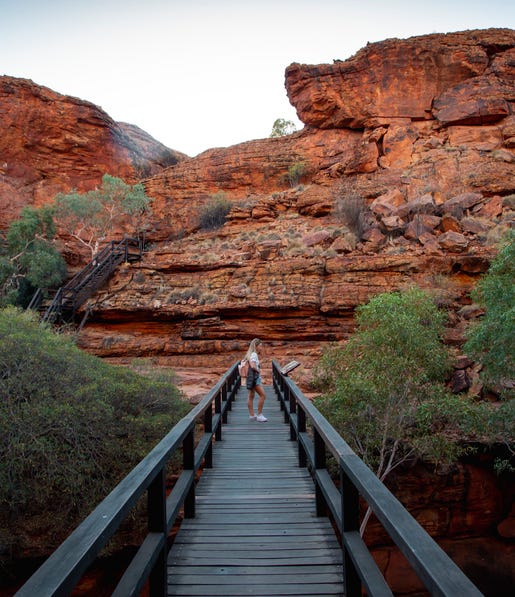 woman reading plaque on a bridge at the kings canyon rim walk