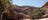 woman standing on a rock by the waters edge looking at ormiston gorge