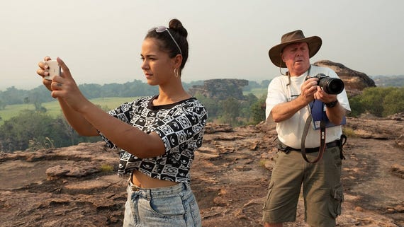 Steve and morgan taking photos from a lookout