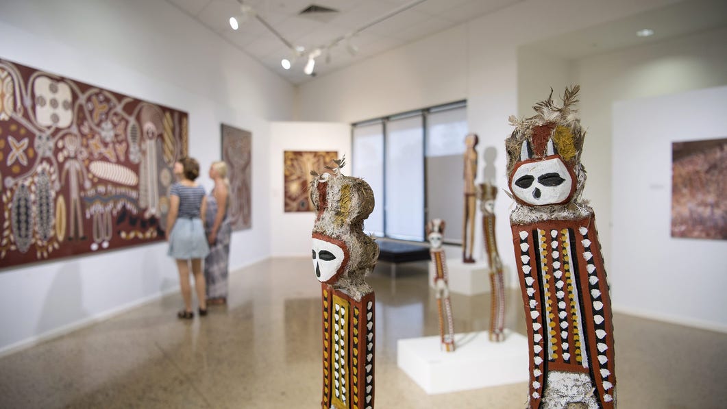 Two girls looking at painting at Godinymayin Yijard Rivers Arts and Cultural Centre
