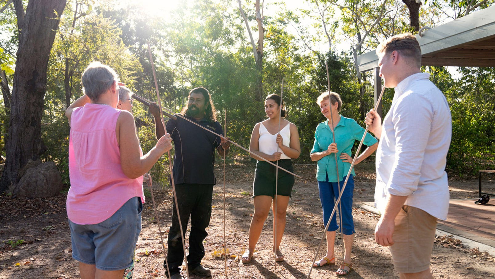 Visitors with spears listening to spear throwing from an Aboriginal guide at Adelaide River Wetland
