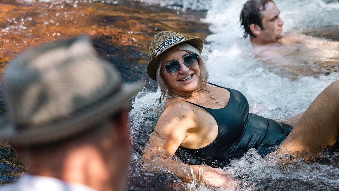 People-in-a-waterfall-with-Cyaround-Tours