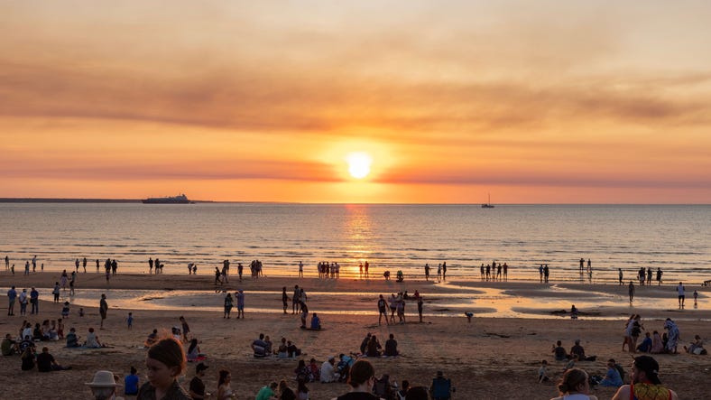 people at mindil beach watching the sunset