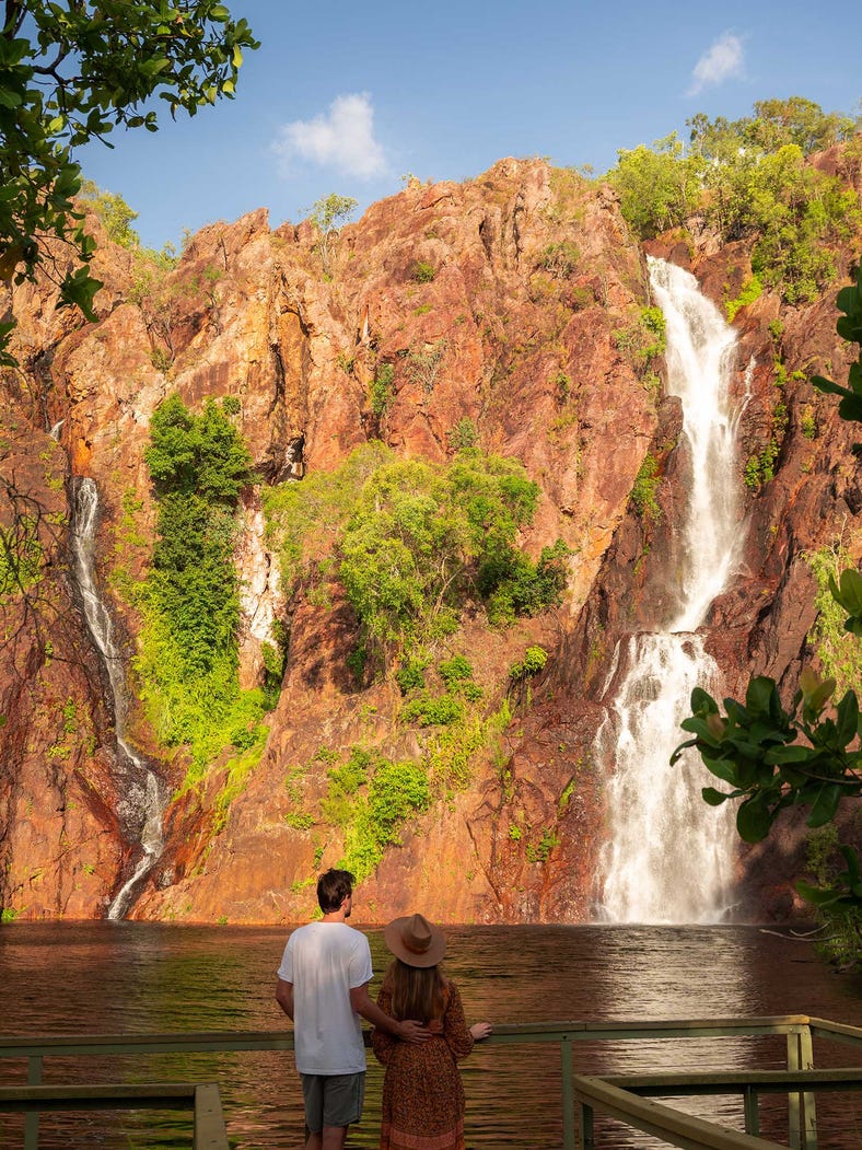 A couple looking at a waterfall in Litchfield