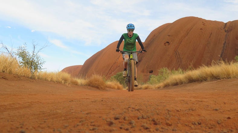 A person mountain biking in Uluru