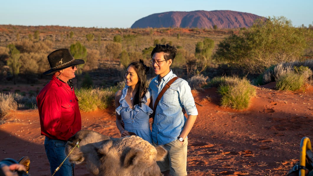 Couple-cuddling-camel-in-front-of-Uuru