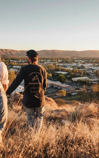 A young couple walking down ANZAC Hill