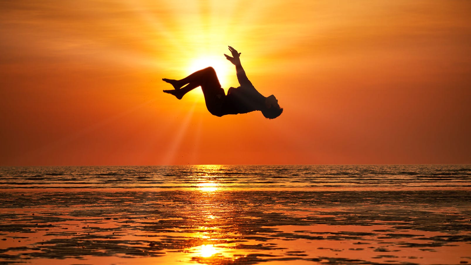 A man summersalting at sunset in Darwin