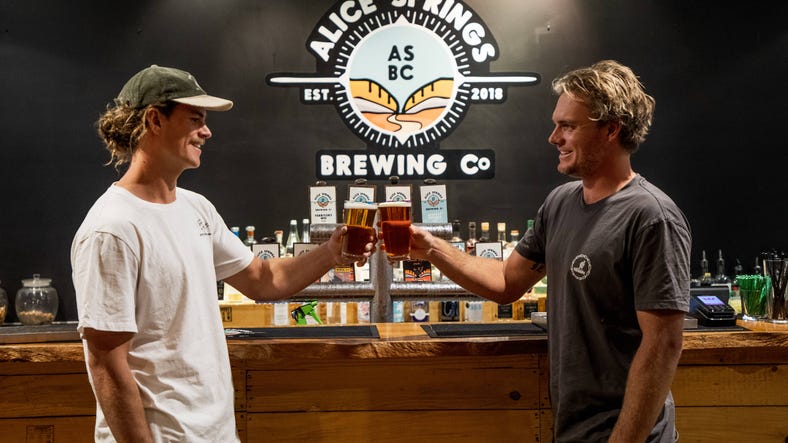 two men cheers with beer