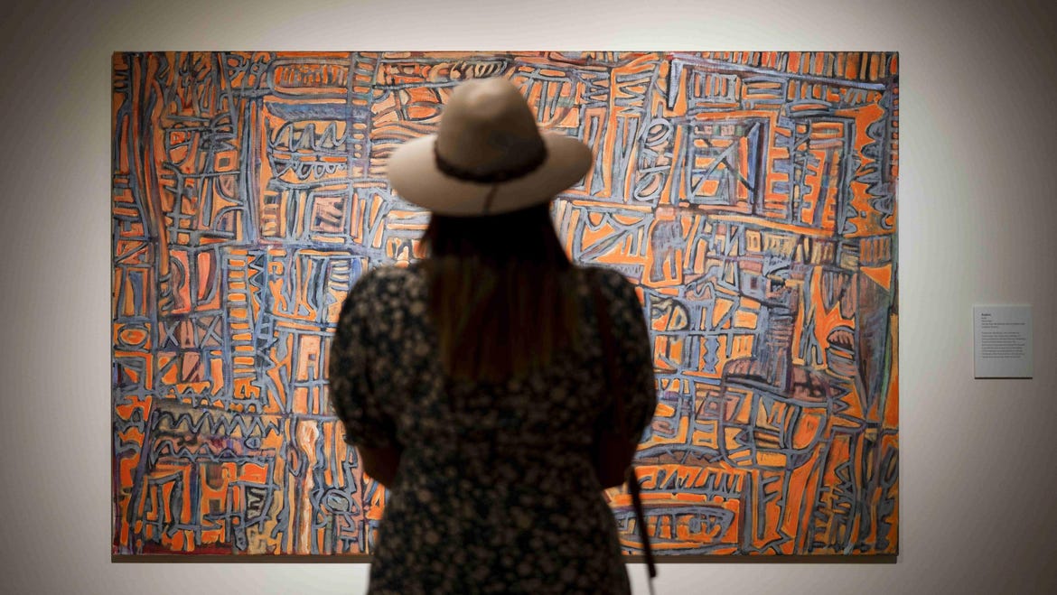 Woman enjoying an art exhibition at the Araluen Art Centre in Alice Springs