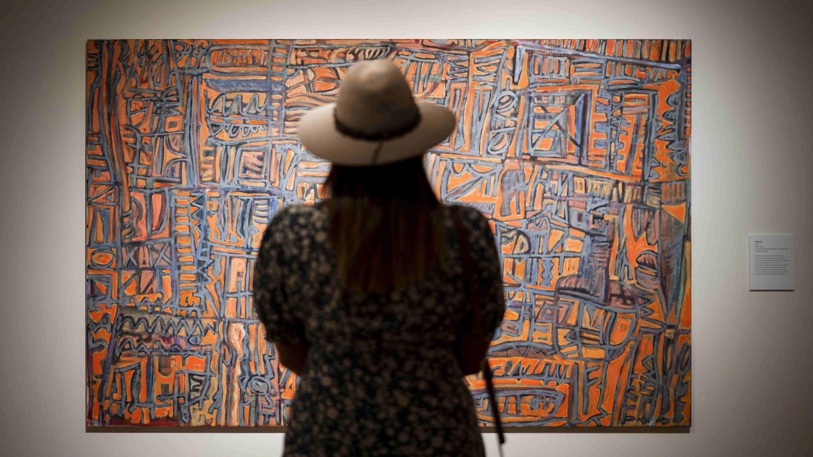 Woman enjoying an art exhibition at the Araluen Art Centre in Alice Springs