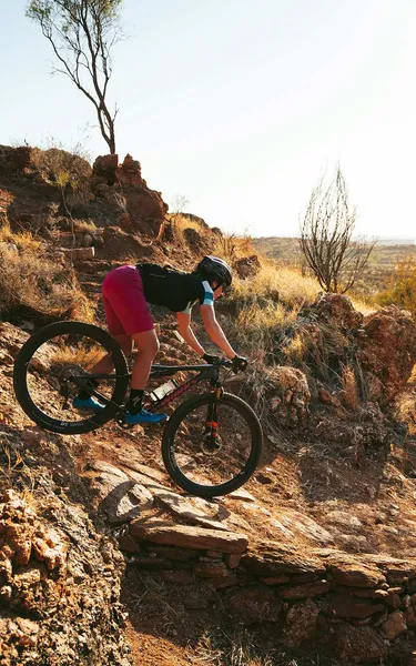 Woman rushing down the rough terrain in Alice Springs