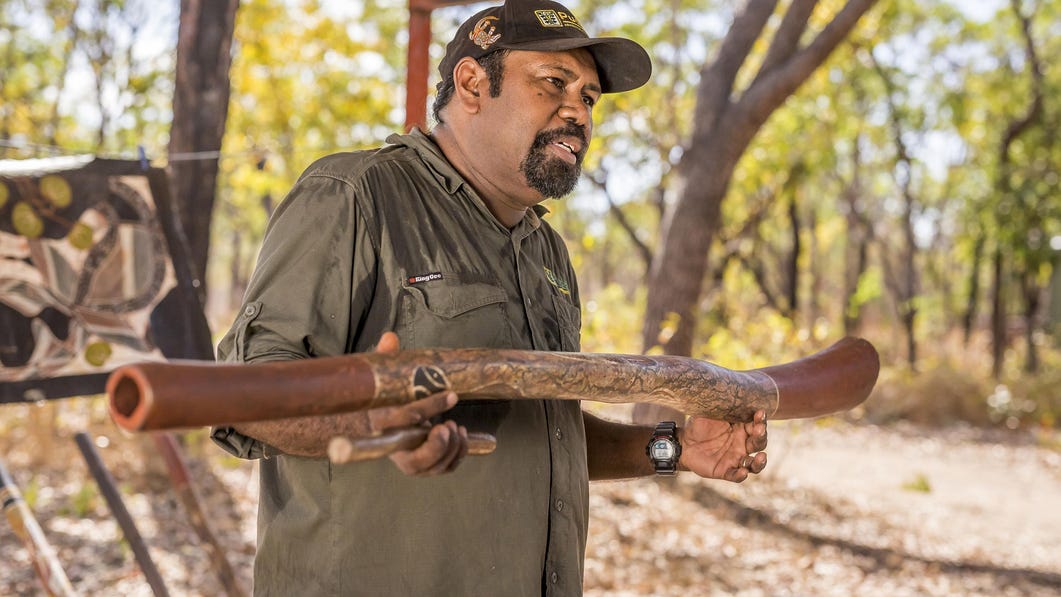 Aboriginal tour guide at Pudakul showing a didgeridoo