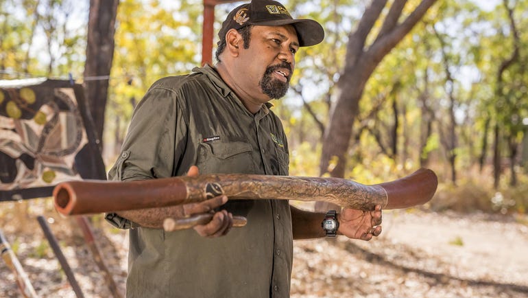Aboriginal tour guide at Pudakul showing a didgeridoo