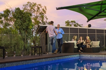 Group of people conversing by the pool at Cicada Lodge in Katherine (1)