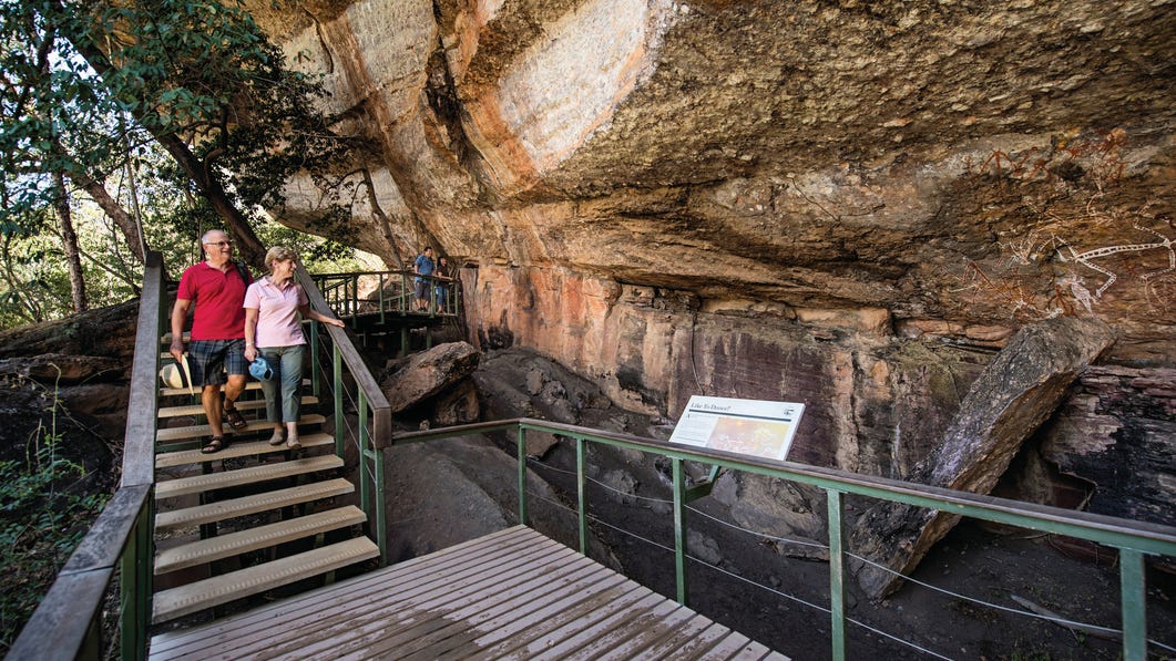 Couple looking at rock art at Mirrai Lookout Kakadu